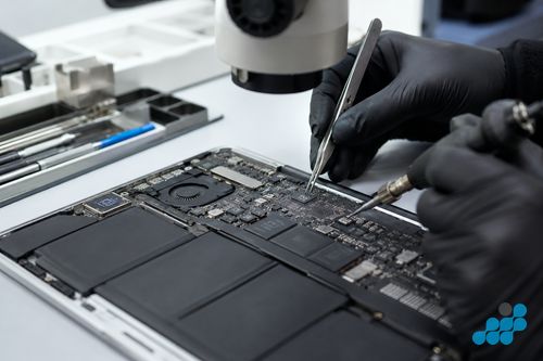 board-level Apple repair on a MacBook logic board