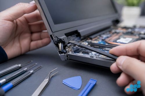 cracked Dell Inspiron hinge corner with the screen cable visible