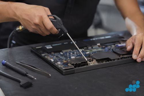 celltech technician cleaning a Dell Inspiron heatsink duct with compressed air