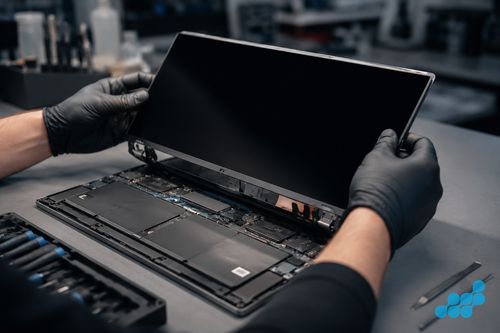celltech technician lifting an XPS 15 InfinityEdge panel from its ultra-slim chassis
