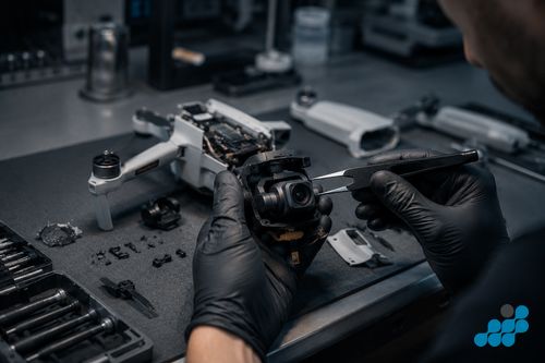 celltech technician repairing a DJI Mini 4 Pro gimbal on the workbench