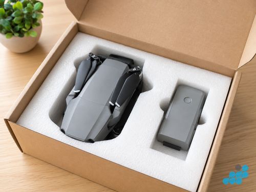 DJI drone packed for mail-in repair — battery removed, foam-lined box