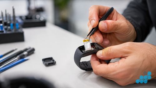 removing a sealed Fitbit battery on the bench
