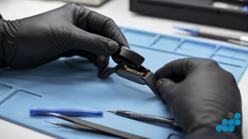 replacing a glued Fitbit screen on the repair bench