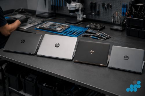 HP Pavilion 15 next to a Spectre x360 on the celltech repair bench for comparison
