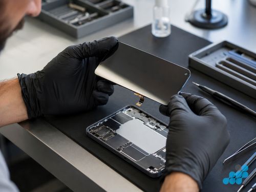 celltech technician inspecting a Nothing Phone (2) OLED screen panel during replacement